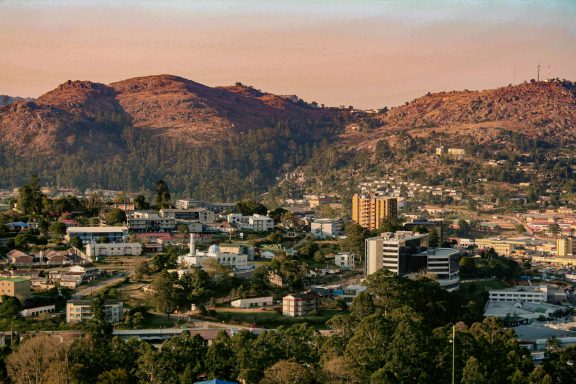 San Jose Del Pacifico Panoramic view of a city nestled among rolling hills at sunset.