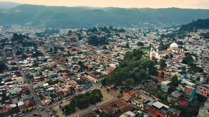 Guanajuato Aerial view of a colorful town surrounded by hills and mountains.